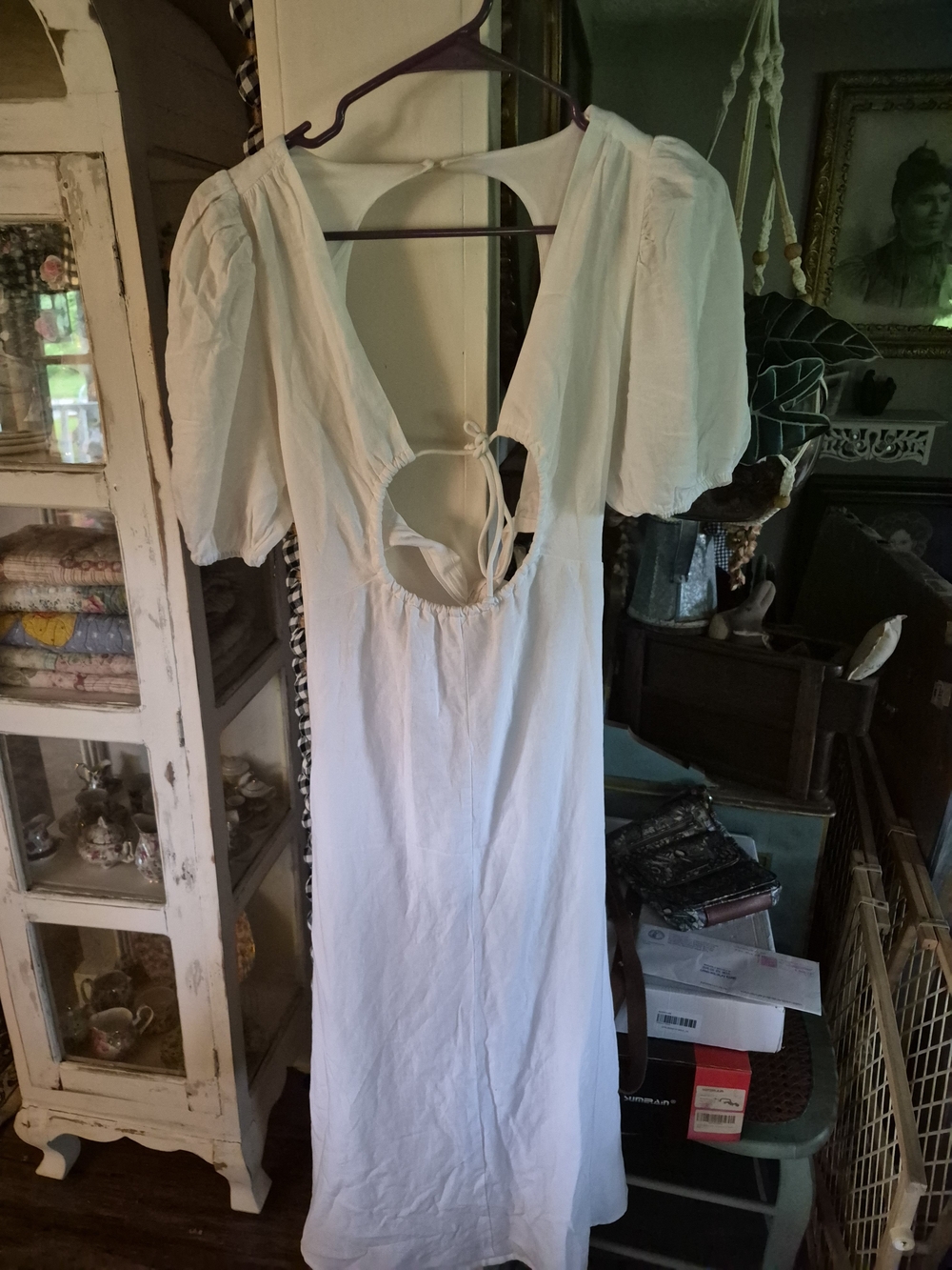 white linen midi dress from More to Come features a dramatic open back